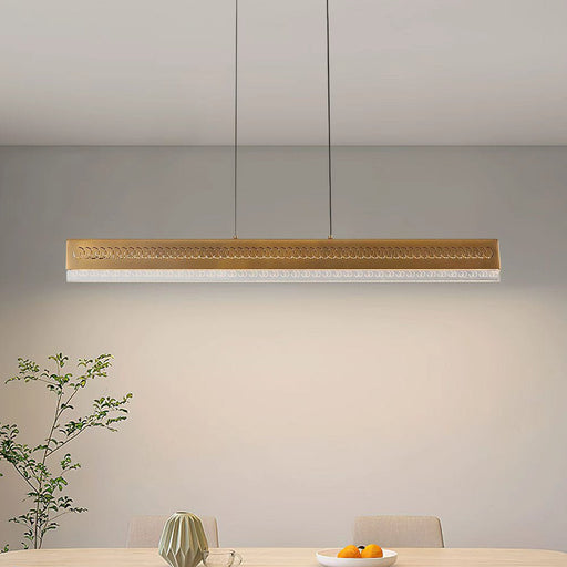 Modern dining area with a long rectangular table and gray chairs, featuring a pendant light.