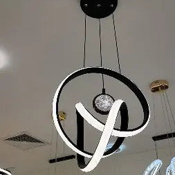 Modern ceiling light fixture with circular design on a white ceiling.